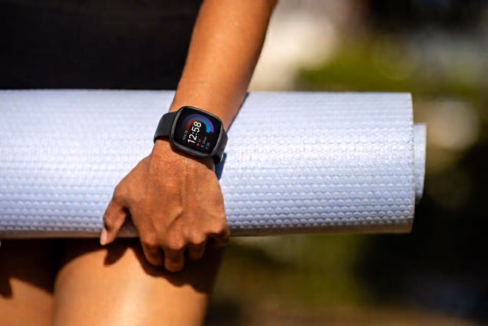 Fitbit Versa 4 smartwatch worn during a workout